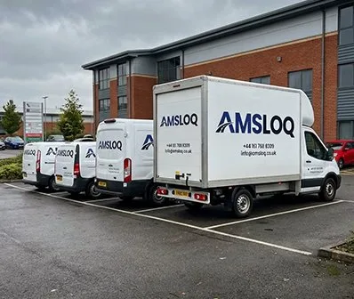 AMSLOQ delivery vans outside the company building