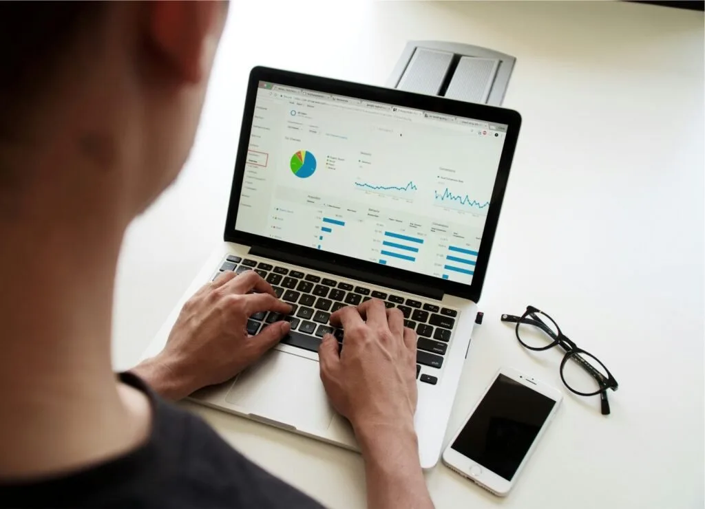 Marketing professional reviewing website traffic and conversion analytics before increasing digital marketing spend.